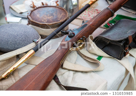vintage rifle with a wooden butt against the background of ammunition vintage rifle with a wooden butt against the background of ammunition 131033985