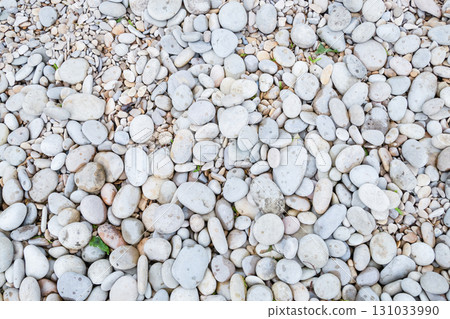 stone light beach close-up of round cobblestones big and small 131033990
