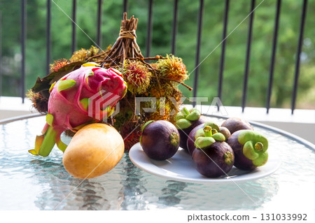 tropical fruits, assorted mango fruits, pitahaya and mangosteen on the table tropical fruits, assorted mango fruits, pitahaya and mangosteen on the table 131033992