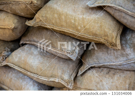 sandbag stacked closeup, protective wall against floods and bad weather sandbag stacked closeup, protective wall against floods and bad weather 131034006