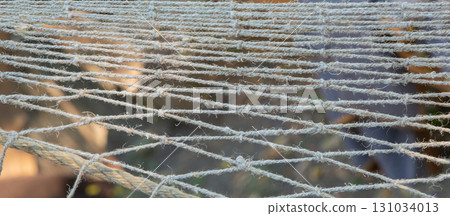 braided fishing net closeup, mesh fabric selective focus braided fishing net closeup, mesh fabric selective focus 131034013