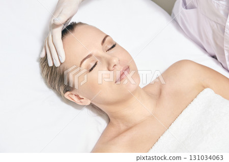 Caucasian female receiving facial treatment at spa with comfortable relaxation Caucasian female receiving facial treatment at spa with comfortable relaxation 131034063