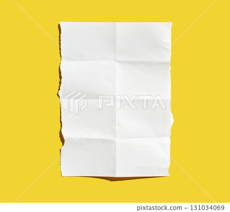 Crumpled white paper sheet on vibrant yellow background highlighting texture 131034069