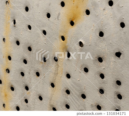 iron sheet with round holes close-up, old, rusty surface iron sheet with round holes close-up, old, rusty surface 131034171