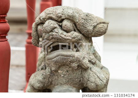 stone sculpture lion in chinese style close-up on the blurred background of the temple 131034174
