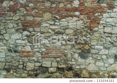 old stone background house wall closeup ,texture stacked of bricks and stones 131034181