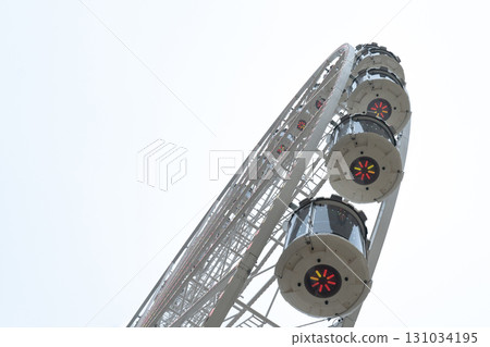 modern ferris wheel close up on gray sky background modern ferris wheel close up on gray sky background 131034195
