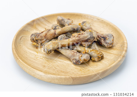 Chicken bone wooden plate leftover food waste white background cooked meal snack unhealthy greasy closeup Chicken bone wooden plate leftover food waste white background cooked meal snack unhealthy greasy closeup 131034214