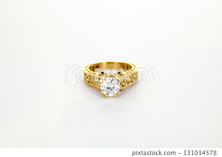 A gold and white ring with a large diamond in the center A gold and white ring with a large diamond in the center 131034578