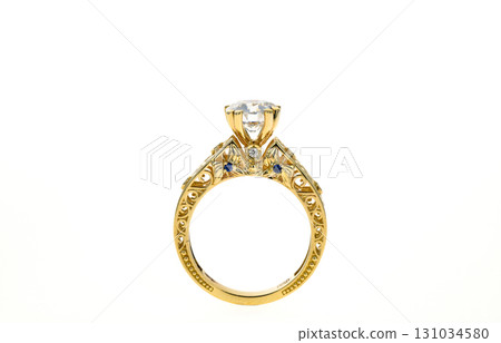 A gold and blue ring with a diamond in the center 131034580