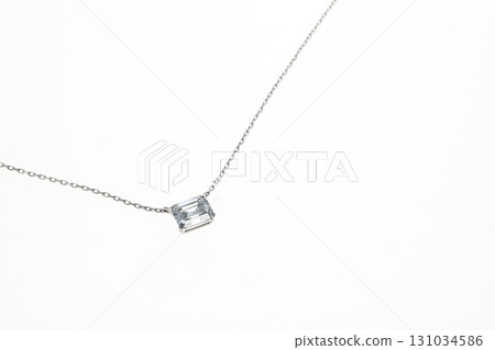 A silver necklace with a blue stone pendant 131034586