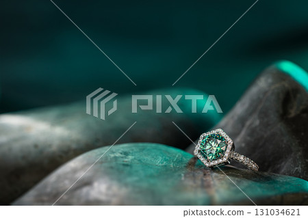 A green stone with a diamond on top of it 131034621