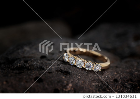 A gold and diamond ring with five diamonds on it A gold and diamond ring with five diamonds on it 131034631