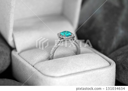 A blue and white diamond ring is in a white box 131034634