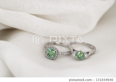 Two green rings are on a white cloth 131034640