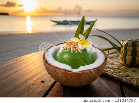 Tropical pandan and coconut jelly dessert served in a coconut shell on a beach at sunset Tropical pandan and coconut jelly dessert served in a coconut shell on a beach at sunset 131034797
