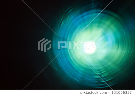 A vibrant and colorful abstract depiction of a tunnel with radiant green and blue light 131036332