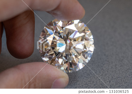 Diamond Holding on Jeweler Hand 131036525