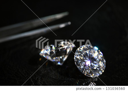 Two diamonds are on a black surface Two diamonds are on a black surface 131036560