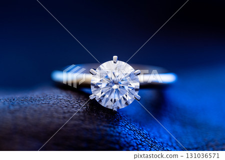Luxury Engagement Diamond Ring on Blue Light Background 131036571
