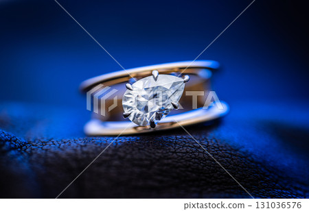 Luxury Gold Ring With Precious Gemstone on Blue Dark Background 131036576
