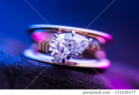 Diamond Ring on Leather With Blue and Purple Light Background Diamond Ring on Leather With Blue and Purple Light Background 131036577