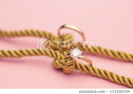 Gold Engagement Diamond Ring on Ropes With Knot 131036594