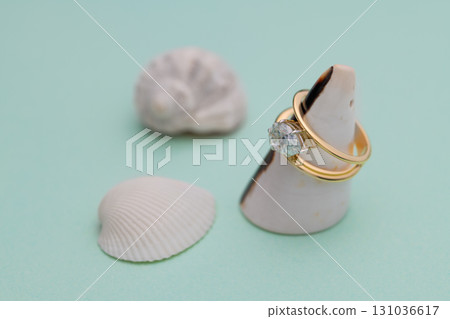 A gold and white ring is displayed on a white base A gold and white ring is displayed on a white base 131036617