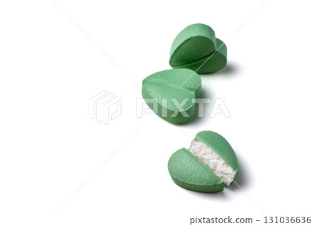 turquoise colored heart shaped cardiology pills cut in half close-up isolated on white background turquoise colored heart shaped cardiology pills cut in half close-up isolated on white background 131036636