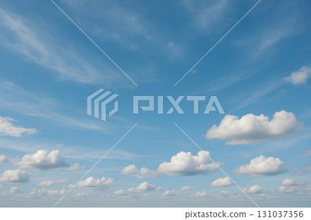 A vast blue sky adorned with soft, fluffy white clouds creates a tranquil and airy atmosphere 131037356