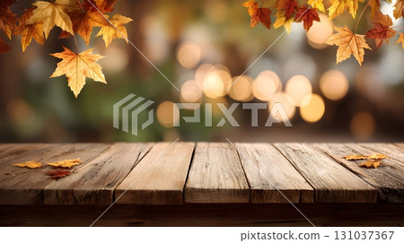 Rustic wooden table adorned with autumn maple leaves and a blurred background. 131037367