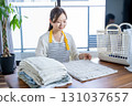 Housewife/housekeeper folding laundry 131037657