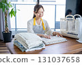 Housewife/housekeeper folding laundry 131037658
