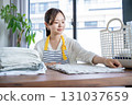 Housewife/housekeeper folding laundry 131037659