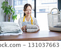 Housewife/housekeeper folding laundry 131037663