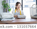 Housewife/housekeeper folding laundry 131037664