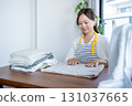 Housewife/housekeeper folding laundry 131037665