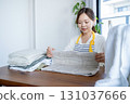 Housewife/housekeeper folding laundry 131037666
