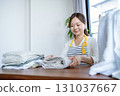 Housewife/housekeeper folding laundry 131037667