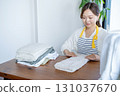 Housewife/housekeeper folding laundry 131037670