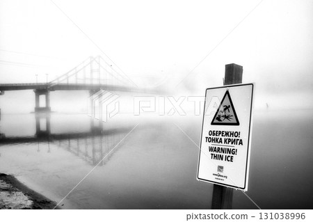 A solitary bridge emerges from the ethereal embrace of mist. A solitary bridge emerges from the ethereal embrace of mist. 131038996