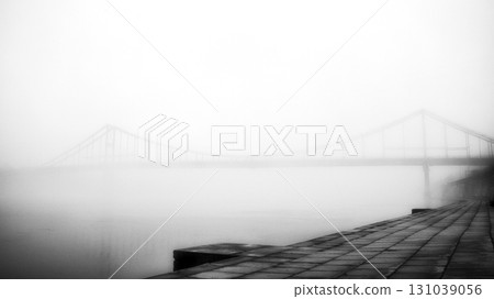 A solitary bridge emerges from the ethereal embrace of mist. A solitary bridge emerges from the ethereal embrace of mist. 131039056