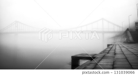 A solitary bridge emerges from the ethereal embrace of mist. A solitary bridge emerges from the ethereal embrace of mist. 131039066