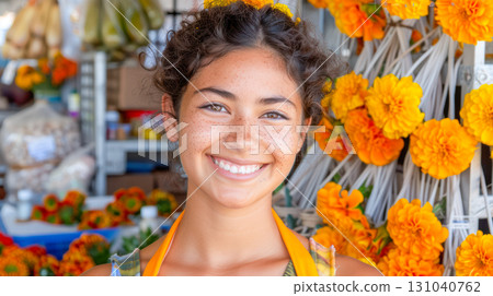 Smiling young woman with curly hair in a vibrant flower market surrounded by colorful blooms 131040762