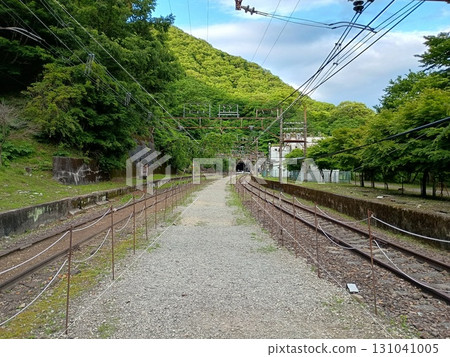 Abandoned railway line and tracks leading to a tunnel in the forest - Kumanodaira Station 131041005
