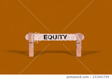 Equity symbol. Wooden stick tightened by Clothespins, beautiful Orange color Backdrop. Business and Equity concept with copy space 131041795