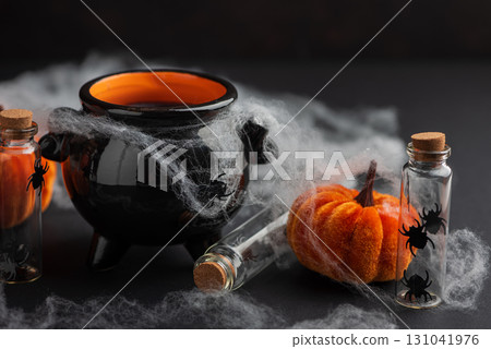 Halloween Cauldron with Pumpkins, Spiders and Cobwebs 131041976