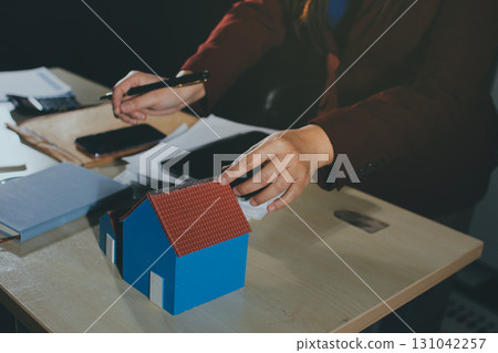 Customer signing a real estate contract in real estate agency. Customer signing a real estate contract in real estate agency. 131042257