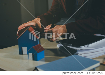 Customer signing a real estate contract in real estate agency. 131042258