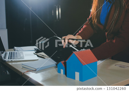 Customer signing a real estate contract in real estate agency. Customer signing a real estate contract in real estate agency. 131042260